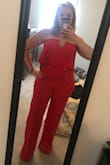Being a curvy girl, I didn't think a jumpsuit would work for my body but tried this one after being unable to find the perfect dress for my brothers Las Vegas wedding. I am pleasantly surprised and absolutely obsessed with this jumpsuit! It fits perfect and the V cutout neckline, which I was very worried about, isn't as revealing on me as it looks on some of the other women in their reviews. I'm wearing 4inch platform heels in the pic and, as you can see, it's very long, but it's nothing a good tailor can't fix for cheap. The color is a perfect warm red and the material is thick without being too heavy. It's designed to stay up and stay put. Give it a try, I think you'll love it too! - Lindsy S.