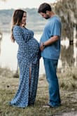 I wore this at 31 weeks pregnant, weighing 195lbs. I normally wear a L so I ordered an XL. SO MAMY COMPLIMENTS on tho dress! Material is light so I wasn't totally miserable outside taking these photos. So happy with this purchase! - Kerri M.