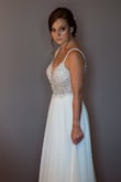 Loved it. I'm small and it fit perfect (only had the hem the length). I got married in Spain so it was a perfect dress to travel with, not bulky at all. It felt more expensive than it was. It also has a little bit of a train on it, overall, I was extremely pleased with the dress. - Eva C.