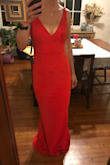 I think this dress is amazing! It has just enough give to be comfortable although it is still form fitting. In the pictures I added, I am wearing a bra and the V in the back goes down juuuuust far enough to see the clasps of the bra in the back. I like the way the V in the front looks much better with my bra on since I have a small chest, so I will either have to rig it to hide the clasps or find a really good pair of sticky bra for the front. I think the Vs are just low enough to still be classy! I also really like the material it is made of - it's not super light but feels thick enough to be durable. For the price, this dress is bomb. I can't wait to wear it to Endymion for Mardi Gras! - Taylor G.