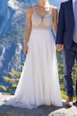 I wore this for my mini mountain wedding and it was perfect. It totally fit my waist, bust, and shoulders upon arrival. I hemmed it (but left a train), added a 3 point bustle, added a hook and eye at the top of the zipper, and changed out the bra inserts for larger coverage (32DD). It was so comfortable that I could hike and it looked fresh and white after 2 hours in the car, stepping through a lake, and more. My husband also loved it. Originally I thought I wanted lace or satin and was nervous about the sparkle bring too "flashy" (I wore no makeup, did my own hair, and have never worn sparkles before) but it was SO flattering against an outdoor background and I've gotten 1000 compliments. It looks and feels much more expensive than it is, and travels much better than many of the other dress fabrics. I tried on some really pricey dresses (and had intended to spend a lot more on a designer dress), but none of them wowed me. On a whim I ordered this based on some links/reviews on a wedding blog, and it was perfect so it was a win all around! Photos are shown from a small shoot two days after the wedding (and the dress still looks white and wrinkle-free despite being dragged around on a dirt trail and thrown in my closet!) - Liz P.