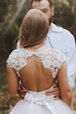 Ordered the smallest dress on website but still too large for me. Easily altered though.
Really like it but it's really see through, need to buy skin colour underwear. Used as a wedding dress with a pink skirt over it, so I could remove the skirt to dance at night. - Amandine B.