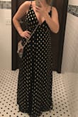This dress looks great on the model but it runs quite large and is really long. I ordered a medium (Generally am a large in tops due to a larger bust) and it was even too big for me. I took it in a bit on the sides and it is quite low cut so double sided tap was needed. The slit was also so high that I had to tape it closed at a reasonable spot as to not flash everyone while dancing. Because it's so flowy, it was very comfortable to wear but definitely needed to be altered by a professional to fit me correctly. I worried about my bits popping out all night if the double sided tape didn't hold. Would recommend for those not well endowed in the chest area and who have the time to get it altered. - Erin M.