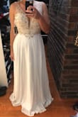 This dress is beyond beautiful! I got this for my reception, because my actual dress is very tight. It's very true to size, and I'm in love with it! It's very sparkly. The pictures don't do the dress enough justice. There is no stretch or give in the zipper area. - Dovie T.