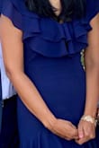 I wore this dress to a wedding and it was perfect. The details on this dress is lovely. The ruffles enhanced by the high/low length made the overall look of this dress stunning. It was also very comfortable and easy to wear all evening. - Somy S.