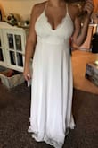 Fits nicely it's a little long so it's better if you plan to wear heels with it. Straps are adjustable which is nice for holding up your boobs if you have big ones! I plan on wearing for my more casual style wedding in the spring - Tiana B.