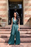 I love this jumpsuit! Every time I've worn it, I've gotten compliments. I'm on the shorter side and usually wear petite, so I got this in XS. It's long, obviously because I'm short, so it goes past my feet. Worn with heels, it's perfect. I didn't need to get it hemmed since I do wear it with heels every time. - Rose A.