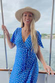 First of all, this color is WOW! I've received a lot of compliments wearing it! Love this dress. It run a little big on me but it's a wrap dress so I just tighten the strings a bit and it's no problem, the slit is just more hidden. The dress ends right below my knees, just for reference. I prefer to casually wear this dress with sneakers. The reason I gave 4 and not 5 stars is because one sleeve is open cut like pictured on the model but the other sleeve isn't. I didn't notice it until the second time I wore the dress and it's not really noticeable. I love the dress so I didn't think the sleeve was worth the return! Recommend! - Erin P.