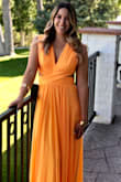 This dress was my favorite online purchase ever! I've never worn orange before, and the color was perfect, exactly like what is shows online. I wore this dress to a wedding and received SO many compliments (including from the bride). The dress is extremely comfy and the way it moves when you walk is stunning. Be prepared for a lot of compliments if you purchase this dress! It also hits the smallest part of your waist and really accentuates it. I also had my dress pressed for wrinkles and a very slight alteration on top. The dress also holds you in nicely and doesn't require a bra or pasties, which is a huge plus! - Jessica M.