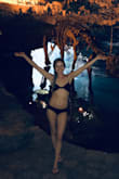 This bathing suit top is good quality, but its cut very low. I wore it to a water park in Mexico and I didn't suffer any malfunctions while wearing it as it is pretty tight. The band in the back is about 3 inches wide, so it will give you a bit of a weird tan line. - Dina B.