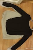 Purchased this sweater in grey, small a while ago. Loved it. Purchased it in black medium a year so later (wanted it to be a bit bigger for cozy style). It was MUCH shorter, much rougher material (washed per insturctions). Really disappointing. - Ashley H.