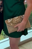 Pretty large clutch, I was able to fit everything I needed in it! My only complaint is feeling like I have to be somewhat careful with it because of the jewels, I had a couple come loose on the first use attending a wedding. - Megan B.
