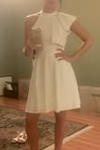 This dress is unique and classy. At first, I didn't know what to think of the one shoulder ruffle, but got used to it. It also photographs well. For fit- usually with stretchy material dresses if it fits my top, it's then tight on my hips. The flare on this dress prevents that issue. - Dana G.