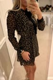 I am obsessed with this dress. It hugs your body perfectly, it's not too short and the tie around the neck is so cute. Looks exactly like pictured. Fabric has no stretch, so I would recommend sizing up if you're in between sizes. - Hanna C.
