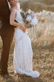 This dress was PERFECT for my wedding. It fit me perfectly and has stretchy material so it was extremely comfortable all day. I can not believe how high quality this dress it for the price! I got tons of compliments on the dress. For alterations, I had to get some length taken off, a triple bustle added, and she sewed two (not visible) little lines under the boob that added a little more form fit to the top.
Highly recommend!!!! - Lauren E.