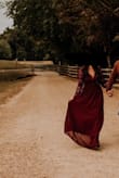 This dress is stunning! I'm typically a medium and was able to order a small and it fit perfect! I'm really short (5'2), I had 2.75 inch heels on and it was still like an inch or two a tad too long but I didn't have time to get it altered before our pictures. You will def have to pick it up as you walk unless you're super tall. - Emily T.