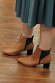 I had to get these when I saw them; I had been looking for some nice brown boots and these are so stylish and unique! They look just as pictured and I agree with some of the other reviews that they are a little tight in the toes - might be good to go a half size up - but they were not so tight that I'm going to exchange them. Will definitely be wearing these a lot this fall and winter! - Karly W.