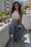 I wear this skirt all the time and it has held up so well. I wash and dry it normally and have never had an issue. Also it barely wrinkles which is so awesome for traveling. I have brought it to several countries already (Greece in the photo below!). I am usually a medium though and did buy a large, so maybe size up if you are unsure. - April L.