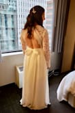 I ordered a large but had it tailored to more of a medium. I also added a slit on the side up to my knee, and I added a bow on the back which I loved! 
The hem was taken up and the chest area brought in to fit me perfectly. I only wore pasties and I think it looked fine. The sleeves fit well so I didn't touch them, which is great because my arms are a bit bigger in proportion to the rest of my body. The skirt has 3 layers which made it really feel like a good quality gown. 
My only negative is the waist band has zero stretch, which doesn't help during dinner hahah. If you get it tailored make sure to request some wiggle room for it. All in all it is a great deal for the price. I have been waiting for a year to write this review and am excited to finally share my own pictures! - Christina B.