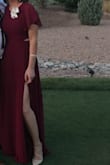 I wore this dress to a wedding and received a ton of compliments. The slit up the leg and the open lower back brought some uniqueness to the dress. It does run a bit large. I am 5'6", and was falling over my dress with heels as I walked. I sent it back for an extra small, and it was a tiny bit shorter in length. Personally I think you may want to size down, because it is a bit on the larger size. Overall the color, style, and quality is great! Alterations for the length is recommended if you at 5'6" or smaller. - Melody C.