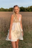 This dress was so perfect for homecoming! I was hesitant because it didn't have any reviews but it is just as beautiful in person! I you have small boobs beware that you will need tape to secure the top of it and possibly the sides. In the picture it almost looks silver but it's definitely a champagne color! The top of it was beautiful and put together very well. It did scratch the sides of my arms some but nothing too bad! Absolutely love this dress!! - Riley P.