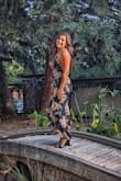 I bought this to wear for a wedding and absolutely love it! I'm typically a size 6-8 and went for the large because I am large chested and the dress does not stretch. It fit perfectly! I absolutely love the pattern and the cut. - Ruth A.