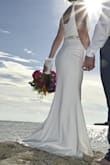 I chose this as my wedding dress, it was perfect for the beach. The quality was insane! I added a belt but as you can see in photos, fit like a glove. Belt and hemming were long alterations needed. No one could tell this wasn't a super expensive dress. - Nicole N.