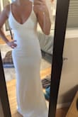 This dress is so beautiful. Ordered it for my wedding and it only needed a 4.5" inch hem. It fit perfectly everywhere except the length. Hugs the curves and has a very elegant and sexy feel and look. Definitely a low cut so be careful bending down! - Brittany S.