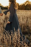 So gorgeous! Wore for my engagement photos and loved it! Fabric is high quality, and a bit on the heavier side thanks to the lining. I am between 5'8" and 5'9" and it was still long enough to graze the ground. Loved the ruffle details on the hem and sleeves! - Trisha A.