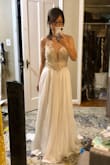 This is a beautiful dress, gives off just enough of the bridal vibe. Simple, classy, and elegant. The top part of the dress where the bead work is however, gives off a more champagne color rather than what's shown in the picture, which was a downside for me. It's also loose for a size 2, and alterations would've cost quite a bit considering the beading and mesh material the tailor would have to work with. I do highly recommend this dress as the bead work is exquisite. - Hannah K.