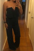 Agh, I loved this jumpsuit in theory! Pros: the color is beautiful (can't see in my picture) - it looks pretty close to the model picture. The top part is very flattering! I tried on without a bra and wasn't too concerned about the fit.  Lastly, it was snug but not too snug to where I felt like you could see my undergarments. Cons: There is no hook in the back of the jumpsuit where the zipper meets the top. I was concerned about the zipper slipping (it didn't during the tryon) but didn't want to risk it. The "v" is a lot lower than I had wanted for the wedding that I am attending. Lastly, the legs were very long (touched floor with two inch wedges) and a little wider than I had hoped. If I had time to make these minor adjustments with a tailor, I totally would've!!! - Ashley-Michelle T.