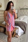 The colors in this dress are gorgeous. The material is super light weight. The wrap style is perfect for a cover-up but that is all I'd wear it for. The front chest area does not stay in place and shifts around making you have to adjust constantly. Also, there is a button to close the first wrap in and the eyelet it buttons to ripped off the first time I put it on. I was able to sew it back on and has been fine since. I would not buy this again but it's still okay enough for me not to return too. - Summer H.
