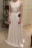 I really like the look of this dress.  I assumed it would be a little too casual for the look I wanted, which it was.  The skirt was heavy and felt high quality.  I could have used an XS size, but only S was available.  I'm sure an XS would have been much better.  The S was really long and baggy on the top and the skirt was pretty long.  I'm short, so most hints I would expect to hem, but bodice would have been harder to alter.  Ordered 5 dresses, ended up choosing a different dress, but this was very nice and SUPER affordable.  Free shipping and return shipping within 10 days is great - take advantage so you can try multiple gowns on!! - Katie P.
