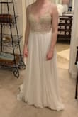I selected this for my wedding dress!!  Saw it on a blog post on Pinterest, was so excited to see it was available for order, and assumed it would be my favorite.  Ordered 5 dresses to compare sizes and styles.  Even after all of that, this was still my favorite.  Free shipping and return shipping within 10 days is great - take advantage so you can try multiple gowns on!!
The dress feels VERY nice in quality, three layers in the skirt, has nice weight and is not see-through.  The netting for the beading at the top is sturdy and blends in well.  My skin is very light and it looked just fine.  The beading feels very high quality and the detail is so beautiful.  
The skirt is a bit too long for me, and the straps will have to be taken up some, but other than that it fit almost perfectly.  There is a slight "train" on the dress.  
Excited to wear this for my wedding, it'll make for the perfect fit and style for a summer time wedding in the mid-west.  GREAT PRICE
Ps - it is much more sparkly in person! - Katie P.