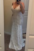 I was a little skeptical but with all the reviews I went ahead and ordered a small and a medium. I ended up keeping the medium since the bust was quite small in the size small. The price point of this dress is perfect for my small wedding and to allow money for alterations (cups and hem) The dress is really long standing at 5'3". In the pic I am on my tip toes. I would recommend this dress. It is a very good quality! - Sheri H.