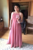 I wore this as a bridesmaid dress and it was perfect. The color of the dress on the model looks more coral, but the dress is actually a rusty rose color like other lulus rusty rose dresses. I had to get the length hemmed, but everywhere else fit great. I'm a standard Small. The dress is polyester, so not breathable on a hot day, but not too bad. - Alix F.