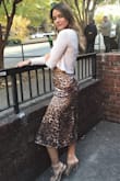 In LOVE with this skirt. The material looks super luxe but is somewhat thin so it's actually pretty form fitting in the booty area. I ended up getting a small which is my normal size and it fits great! Would definitely recommend. - Erika T.