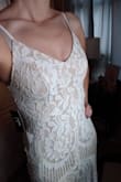 This dress was ALMOST perfect for what I wanted for my wedding. It fit me well, was flattering, great length in the train (not too long or too short), the lace was pretty and felt like good quality for the price. My only complaint was that they don't show an up-close picture of the dress, because underneath the white lace it is not white at all... it's a tan/beige color that shows through easily making this NOT a white dress. I was pretty surprised since most of the pictures showed me a "white" dress. If the material underneath had been white, I definitely would have kept this dress, but it wasn't so I returned it. - Kate K.
