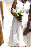 This dress was perfect. The heavy material kept from blowing the dress everywhere when it got windy. I got married in this dress at the beach, and was almost 4 months pregnant and had a bump already, but it still fit. It was perfect!! Wish I had hips to fill it out better, but I loved it anyways. The lace wasn't itchy either and it has a light material under the lace. - Christin C.