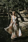 I knew I had to have this dress for my engagement photos. It's a wrap dress so it can fit as loosely or as snug as you want. I did have to have it altered for length, but it could work with higher heels. The material is thick and feels great. I wore a stick-on bra with it, strapless might show in the back. - Jenna H.