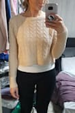 I love the design of this sweater a lot but it is TINY compared to what is depicted on the model. I normally wear a small. This is too short even on my super short torso (in my opinion). It's definitely a crop top. The tank I'm wearing in the photo is cropped. If this sweater is made in another color like white or grey I would reorder in an L/XL. - Allison G.