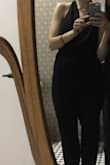 I am 5'8" and purchased a medium. It was slightly large on the top, but I wouldn't have gone down a size because the pants were slightly short. I would absolutely recommend this jumpsuit. I dressed it up with heels and wore it to a wedding. The only downside is that the two buttons on the neck are quite small, and it was difficult to get in and out of to use the restroom... I had to rely on friends to help me with this! - Rebecca D.