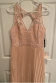 The dress is pretty but the color is nothing like the pictures. It's more of a pale pink skin color tone, runs rather large, won't be able to use it for the event I have planned. - Ana C.