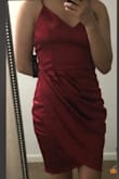 This dress comes out as a ruby red in person compared to the photos. I'm short so the dress was not as short as I thought it would be compared to the model and hits me slightly 1/4 above my knee. Not quite midi but it is a beautiful design and very thick satin dress. Good quality dress but I don't think I am confident enough to wear the dress to any events that I know of. - Jade J.