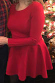 I wore this dress to our annual work Christmas party and was very comfortable in it. I ordered a Medium because I thought the top part of the dress would look better a little more fitted and it was perfect. The bottom half of the dress is less fitted and more forgiving. The material was thicker than I expected which was a nice surprise since it was cold the night of the Christmas party. You can easily dress it up or down. Perfect winter dress. - Joanna L.