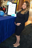 I wore this for my baby shower at 28 weeks pregnant! The perfect amount of stretch. I am normally a small or a medium and I wore this in a small and had plenty of room for my bump! - Jacque L.