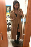 I love the style and color. The color is perfect and just what I was looking for, a darker camel/tan color. The style from the waist up is great and looks really flattering. I'm 120lbs and I usually wear an XS in Lulus dresses and occasionally a S for certain tops and bottoms. 
The reason I took off a star is because it's a bit too oversized and way too long. Unless you're a model that is taller than 5'10" or wearing really tall heels, this coat would probably swallow you. Also, it is very thin for an $84 coat. I'd say it's more of a long light jacket than a coat to really keep you warm. I'm keeping it anyway because I got it on sale on Black Friday and I plan to have it taken up so it's not as long. I bought 4 similar coats from Lulus and this is the only one I'm keeping. It pretty much looks exactly how it's pictured on the model. - Lam T.