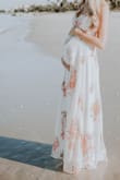 Currently 7 months pregnant and got this dress for my maternity shoot/baby shower. I am SO pleased it's  absolutely  gorgeous. Colors and flow are exactly what I was looking for! 
I'm 6"1', usually a Small & 134lbs. At 7 months pregnant I ordered a Medium and am 146lbs - it fit perfectly!
I'm adding a few pictures for reference. - Julia F.