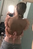 I was looking at this bodysuit for a while, it's much pinker than the photo but the back is super cute. It was kind of hard to get over my butt though, it made a bunch of scary thread ripping noises but once on it looks nice. The back is to die for but I would not recommend this bodysuit if you are above a C cup size, the cups are small and padded so you can wear it without a bra but it's pretty loose so I wear it with a sticky bra, but if you have a larger bust this for sure would not work because there's simply not enough space. - Sophia G.