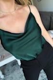 I absolutely love this bodysuit. I wore it to a friend's engagement party with black slacks. I like that it has adjustable straps and stays "tucked in." I am a 34D and was able to wear boob tape and hide it well while wearing this top. Highly recommend! - Katherine B.